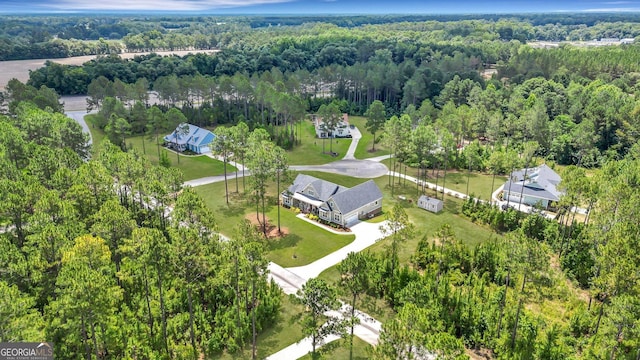 birds eye view of property with a forest view