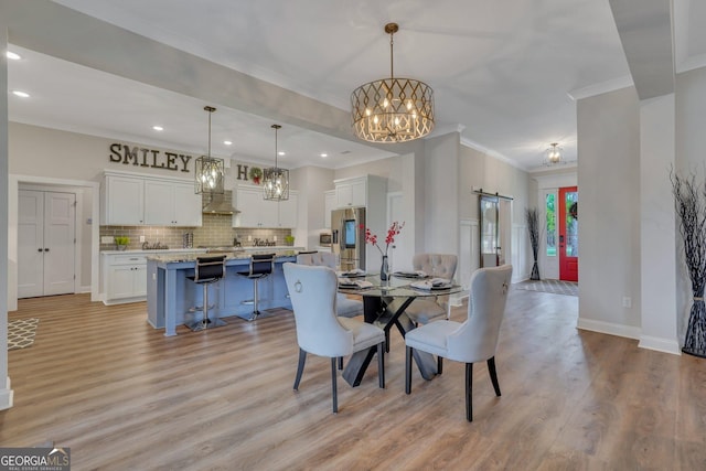dining area featuring light wood-style flooring, baseboards, recessed lighting, a chandelier, and crown molding