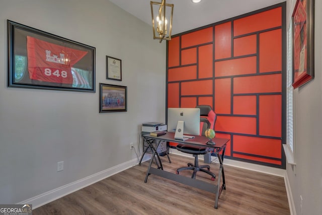 home office featuring baseboards, a notable chandelier, and wood finished floors
