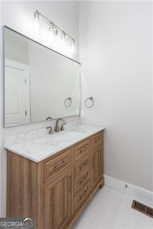 3286 Bachelor St, East Point, GA 30344 - bathroom featuring baseboards, visible vents, marble finish floor, and vanity