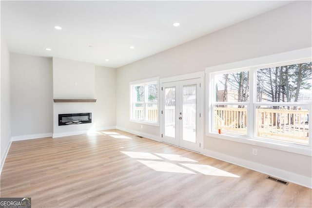 3286 Bachelor St, East Point, GA 30344 - unfurnished living room with visible vents, light wood finished floors, baseboards, and french doors
