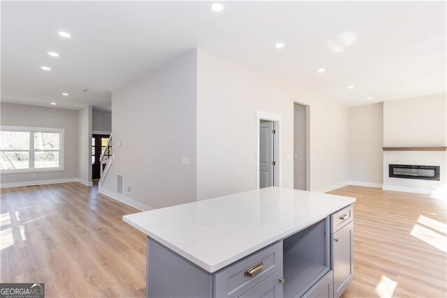 3286 Bachelor St, East Point, GA 30344 - kitchen with light wood-type flooring, open floor plan, recessed lighting, gray cabinetry, and a kitchen island