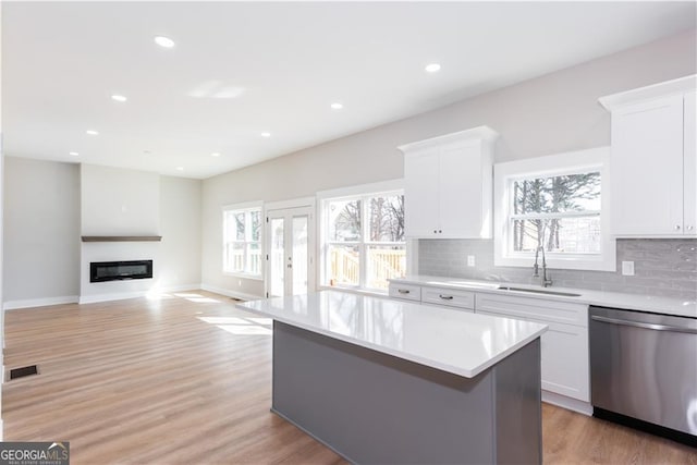 3286 Bachelor St, East Point, GA 30344 - kitchen featuring stainless steel dishwasher, visible vents, a sink, and a healthy amount of sunlight
