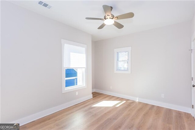 3286 Bachelor St, East Point, GA 30344 - unfurnished room with baseboards, light wood-style flooring, visible vents, and a ceiling fan