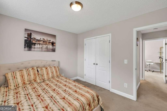 180 Laurel Oaks Ln, Jefferson, GA 30549 - carpeted bedroom featuring a textured ceiling, a closet, and baseboards