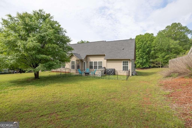 180 Laurel Oaks Ln, Jefferson, GA 30549 - back of property with a lawn and roof with shingles