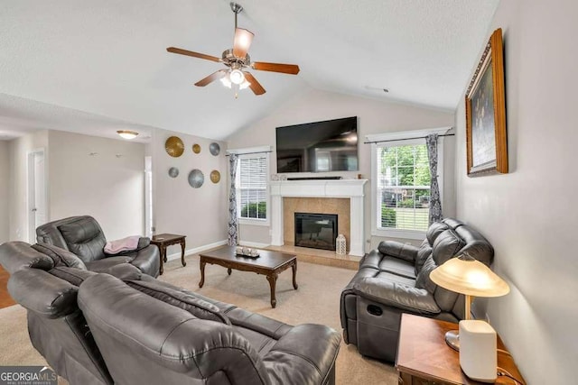 180 Laurel Oaks Ln, Jefferson, GA 30549 - living room featuring ceiling fan, light carpet, vaulted ceiling, a tile fireplace, and baseboards