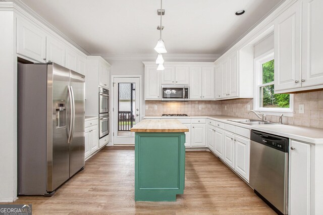 732 Sweet Gum Way, Canton, GA 30115 - kitchen featuring white cabinets, a center island, a sink, butcher block countertops, and appliances with stainless steel finishes