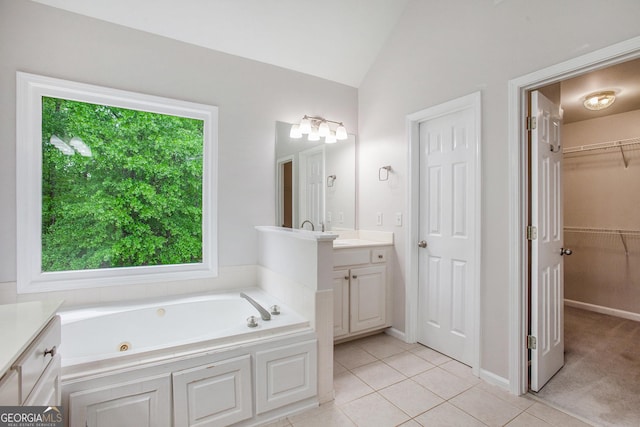 732 Sweet Gum Way, Canton, GA 30115 - full bathroom with a spacious closet, tile patterned floors, vaulted ceiling, a jetted tub, and vanity