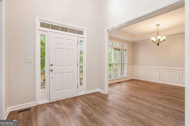732 Sweet Gum Way, Canton, GA 30115 - foyer with a tray ceiling, wood finished floors, visible vents, crown molding, and a chandelier