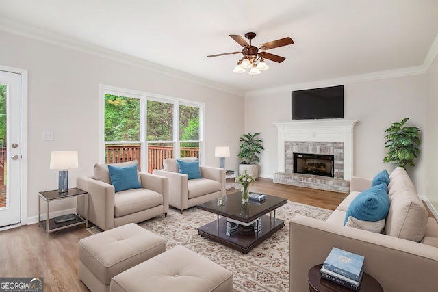 732 Sweet Gum Way, Canton, GA 30115 - living room with a ceiling fan, crown molding, light wood finished floors, a fireplace, and baseboards