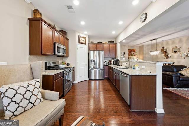 kitchen featuring a peninsula, visible vents, appliances with stainless steel finishes, and dark wood finished floors