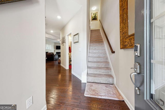 entryway featuring stairway, baseboards, wood finished floors, and recessed lighting