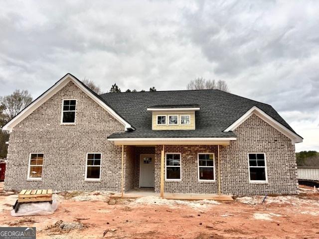 craftsman house featuring brick siding