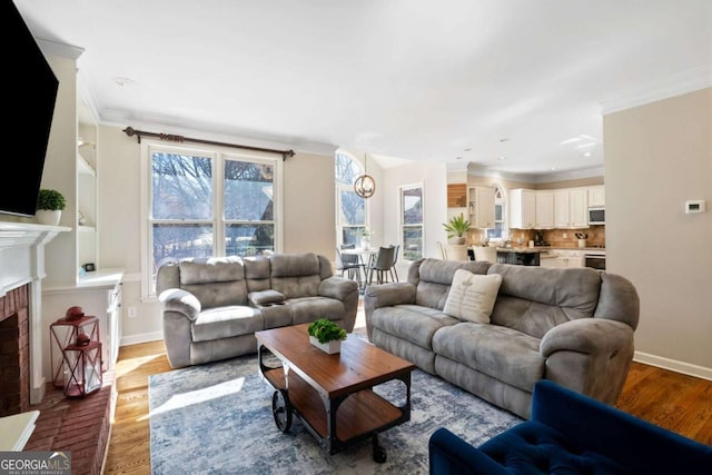 720 Lakeglen Dr, Suwanee, GA 30024 - living area featuring wood finished floors, crown molding, and a brick fireplace