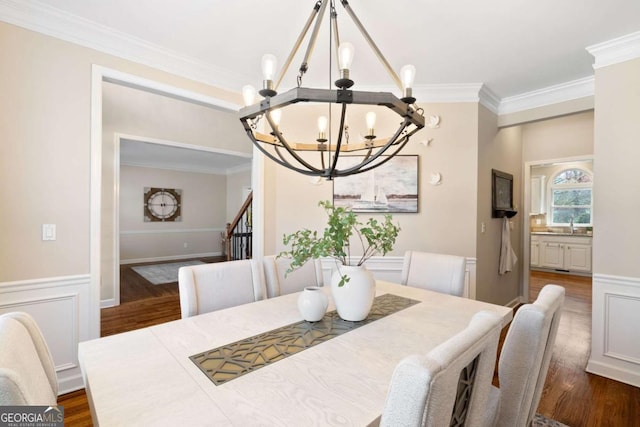 720 Lakeglen Dr, Suwanee, GA 30024 - dining room featuring a chandelier, ornamental molding, dark wood-style flooring, stairs, and a wainscoted wall