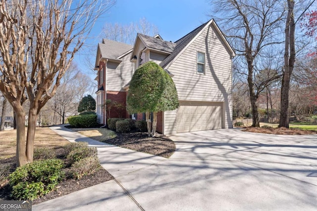 720 Lakeglen Dr, Suwanee, GA 30024 - view of home's exterior with an attached garage, driveway, and brick siding