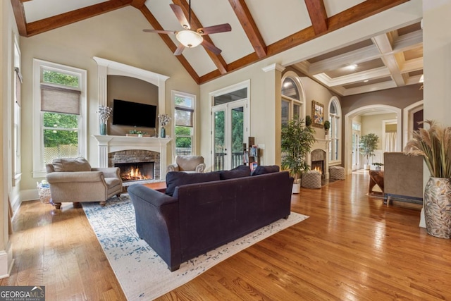 2551 Raintree Dr NE, Atlanta, GA 30345 - living area with beamed ceiling, a fireplace, light wood-type flooring, and ceiling fan