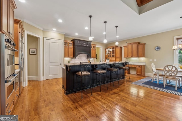 2551 Raintree Dr NE, Atlanta, GA 30345 - kitchen with brown cabinetry, recessed lighting, and glass insert cabinets