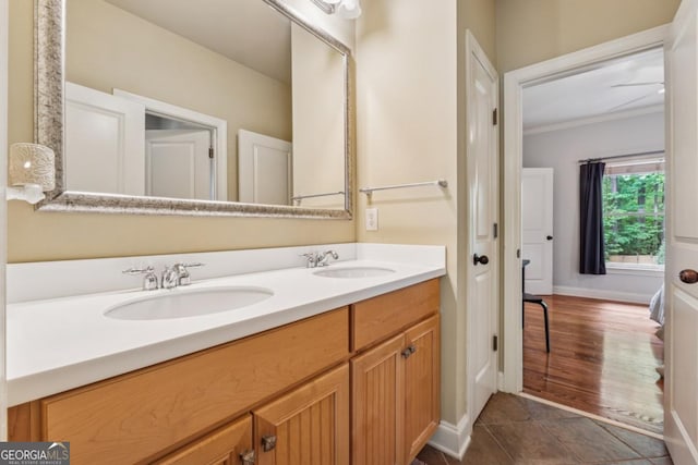 2551 Raintree Dr NE, Atlanta, GA 30345 - bathroom featuring baseboards, ornamental molding, a sink, and double vanity