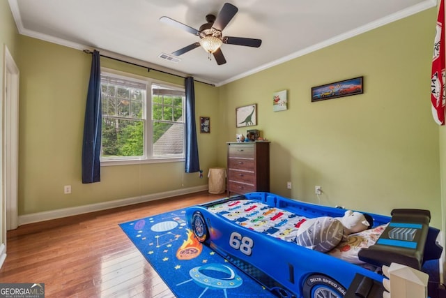 2551 Raintree Dr NE, Atlanta, GA 30345 - bedroom with wood finished floors, visible vents, a ceiling fan, ornamental molding, and baseboards