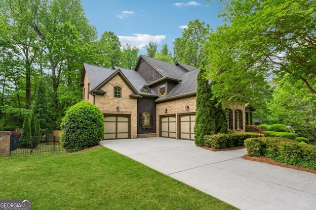 2551 Raintree Dr NE, Atlanta, GA 30345 - view of front of property featuring a front lawn, driveway, stone siding, an attached garage, and fence