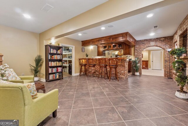 2551 Raintree Dr NE, Atlanta, GA 30345 - living area featuring arched walkways, visible vents, recessed lighting, tile patterned flooring, and indoor wet bar
