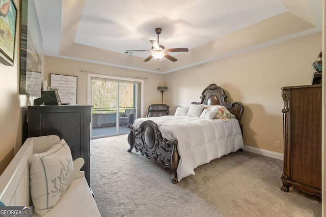bedroom with a raised ceiling, carpet, access to exterior, and ceiling fan