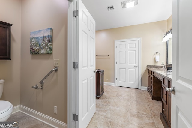 bathroom with baseboards, visible vents, vanity, and toilet