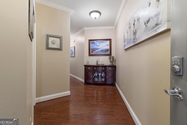 corridor with wood finished floors, crown molding, and baseboards