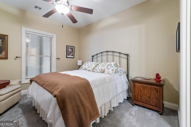 carpeted bedroom with visible vents, a ceiling fan, and baseboards