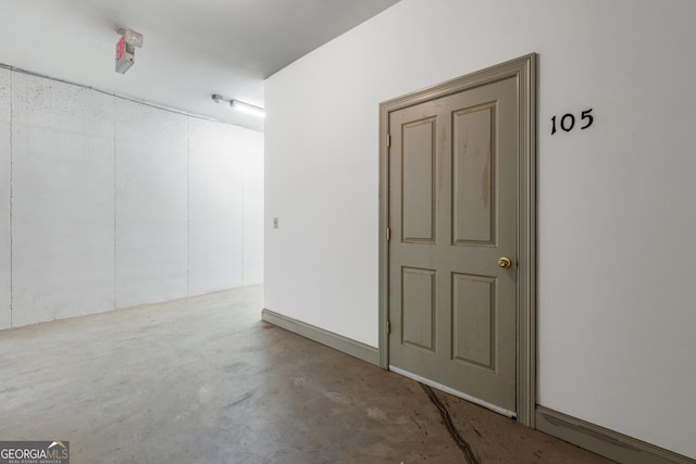 unfurnished room featuring unfinished concrete flooring