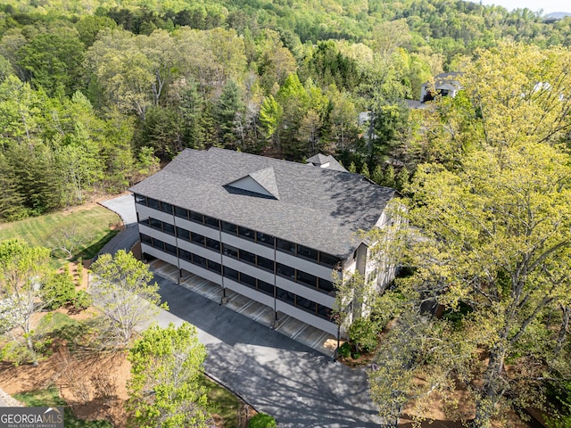 birds eye view of property featuring a view of trees