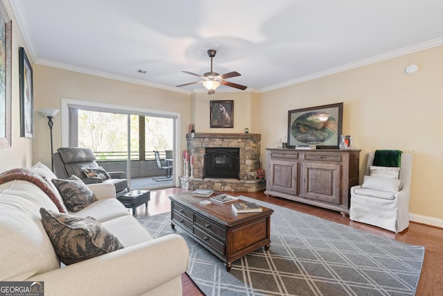 living area featuring wood finished floors, crown molding, and ceiling fan