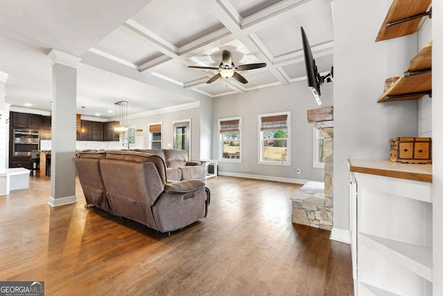 living room with a ceiling fan, baseboards, beam ceiling, dark wood-style floors, and decorative columns