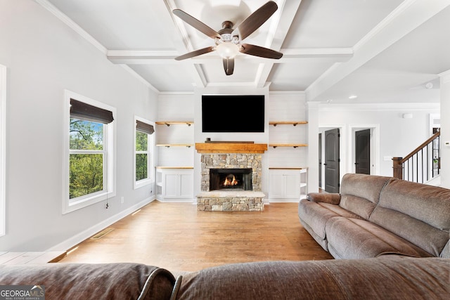 living room with coffered ceiling, a ceiling fan, beamed ceiling, light wood-style floors, and a fireplace