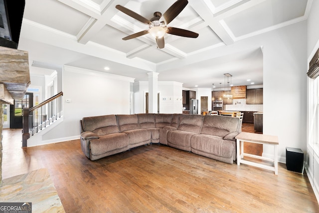 living area with light wood-style flooring, recessed lighting, coffered ceiling, beamed ceiling, and a ceiling fan