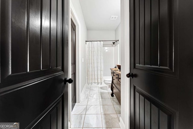 full bath featuring marble finish floor, toilet, visible vents, and baseboards