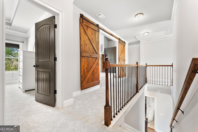hallway with carpet floors, ornamental molding, an upstairs landing, and baseboards