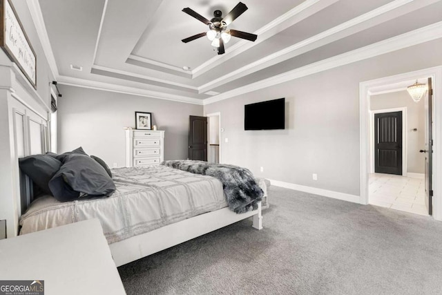 bedroom featuring carpet, a raised ceiling, visible vents, ornamental molding, and baseboards