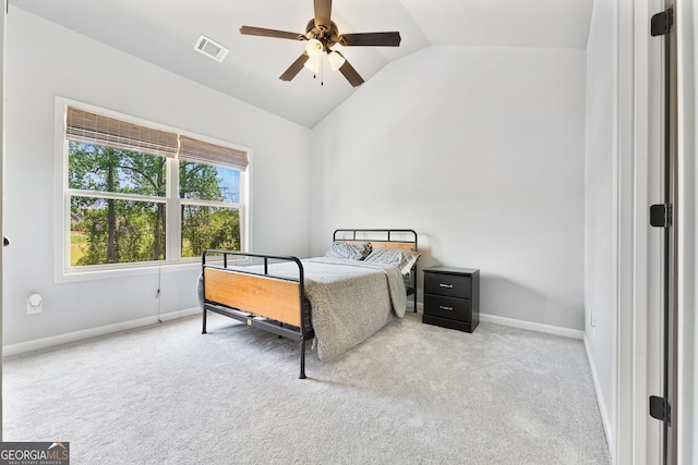 carpeted bedroom featuring lofted ceiling, baseboards, a ceiling fan, and visible vents