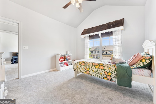 carpeted bedroom with vaulted ceiling, a ceiling fan, and baseboards