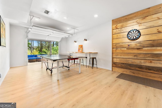 playroom featuring a garage, baseboards, wood finished floors, and recessed lighting