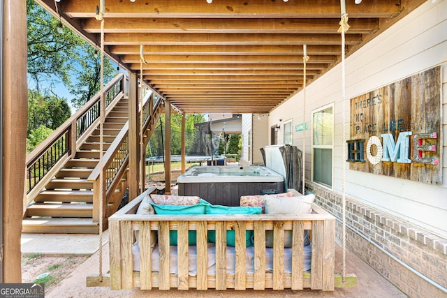 view of patio featuring a hot tub and stairs