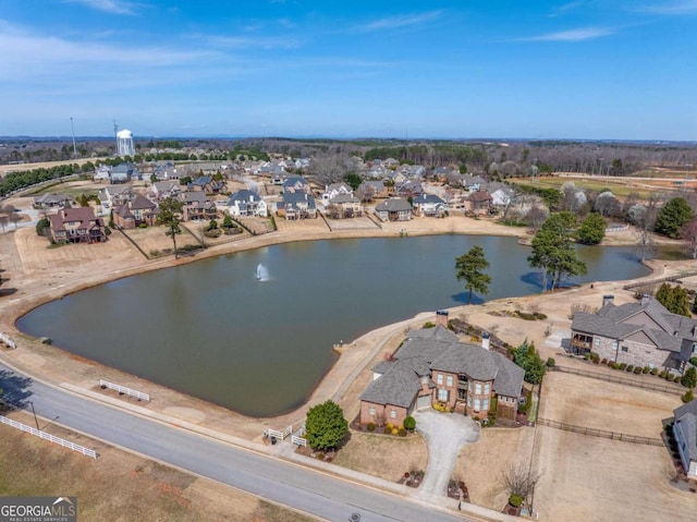 birds eye view of property featuring a water view and a residential view