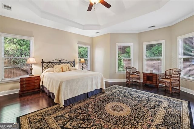 bedroom featuring baseboards, multiple windows, dark wood-type flooring, and crown molding