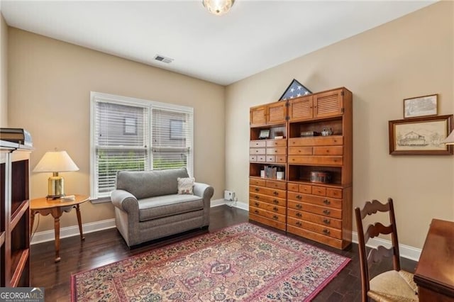 sitting room featuring baseboards and wood finished floors