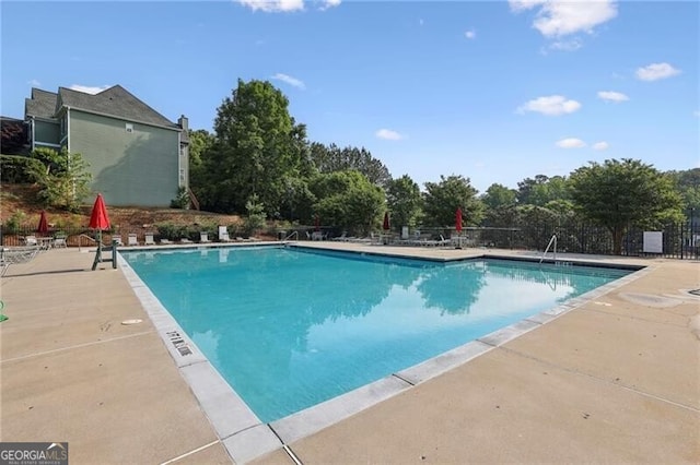 community pool with a patio area