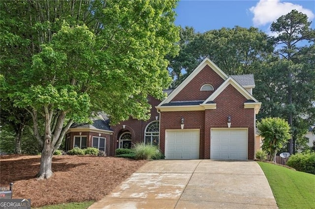 view of front of home featuring driveway, brick siding, and a garage