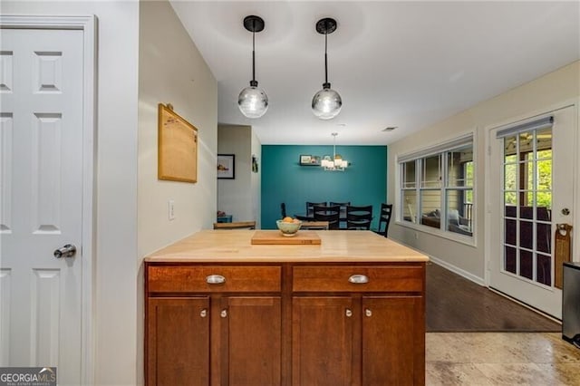 72 Griggs St SW, Marietta, GA 30064 - kitchen featuring light countertops, a chandelier, pendant lighting, a peninsula, and brown cabinets